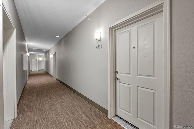 hall with baseboards and carpet