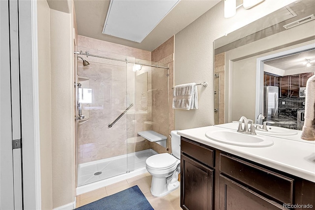 full bathroom with tile patterned flooring, a stall shower, toilet, and vanity