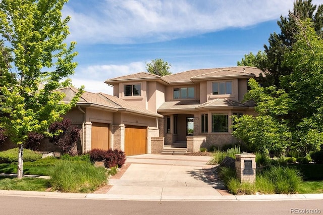 2535 W 115th Dr, Westminster, CO 80234 - prairie-style home with concrete driveway, brick siding, stucco siding, and an attached garage