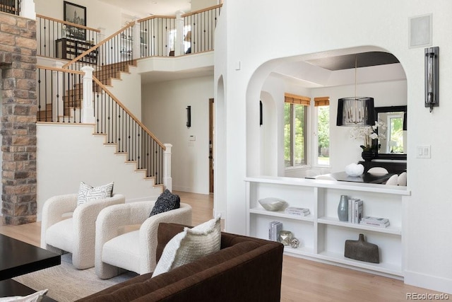 2535 W 115th Dr, Westminster, CO 80234 - living room featuring arched walkways, wood finished floors, and stairs