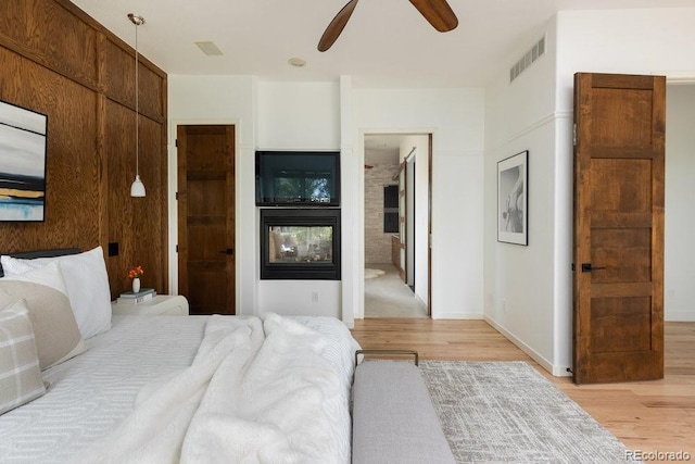 2535 W 115th Dr, Westminster, CO 80234 - bedroom with light wood finished floors, connected bathroom, and ceiling fan