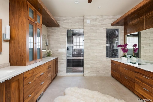 2535 W 115th Dr, Westminster, CO 80234 - bathroom with tile patterned flooring, double vanity, a shower stall, and tile walls