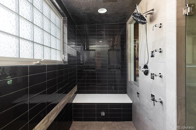 2535 W 115th Dr, Westminster, CO 80234 - bathroom featuring tiled shower and tile walls