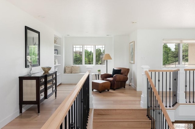 2535 W 115th Dr, Westminster, CO 80234 - corridor featuring an upstairs landing, light wood-type flooring, built in features, and baseboards
