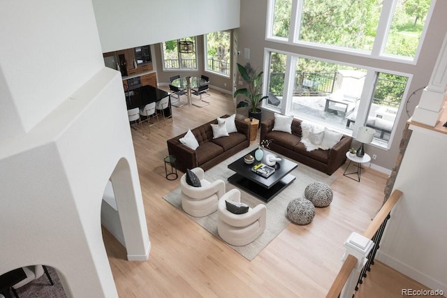2535 W 115th Dr, Westminster, CO 80234 - living room with wood finished floors, baseboards, and a high ceiling
