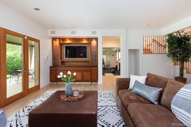 2535 W 115th Dr, Westminster, CO 80234 - living room with light wood-style floors, french doors, and baseboards