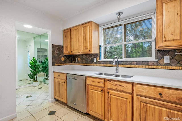 kitchen featuring dishwasher, a sink, light tile patterned floors, backsplash, and light countertops