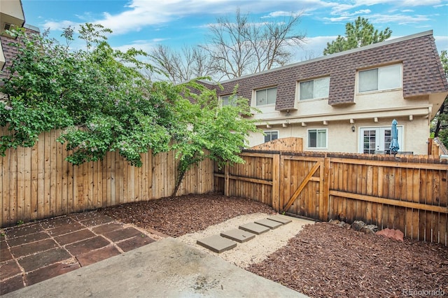 fenced backyard featuring a gate
