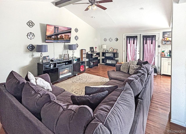 living room with lofted ceiling with beams, hardwood / wood-style flooring, ceiling fan, and french doors