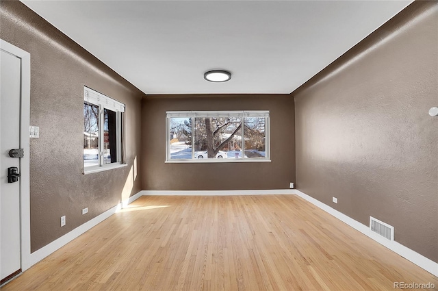 empty room with light hardwood / wood-style floors