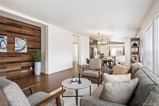 1522 Willow St, Denver, CO 80220 - living area with dark wood-style floors, a chandelier, baseboards, and wooden walls