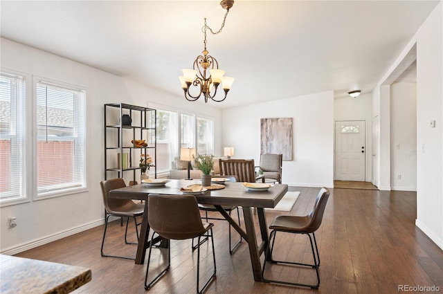 1522 Willow St, Denver, CO 80220 - dining area featuring a chandelier, dark wood finished floors, and baseboards