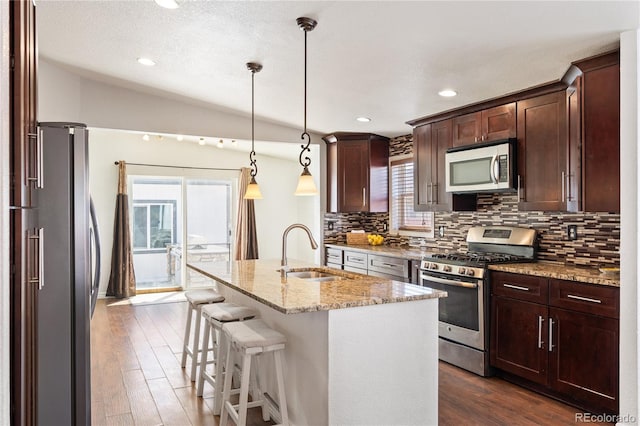 1522 Willow St, Denver, CO 80220 - kitchen featuring appliances with stainless steel finishes, a sink, plenty of natural light, backsplash, and recessed lighting