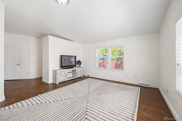 1522 Willow St, Denver, CO 80220 - unfurnished living room featuring dark wood-style flooring, vaulted ceiling, and baseboards