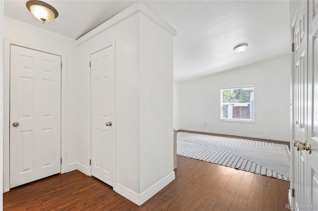 1522 Willow St, Denver, CO 80220 - entryway featuring dark wood-style floors, baseboards, and vaulted ceiling