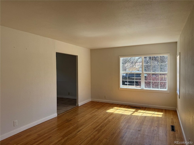 1906 Larkspur Dr, Fort Collins, CO 80521 - unfurnished room featuring a textured ceiling, wood finished floors, baseboards, and visible vents