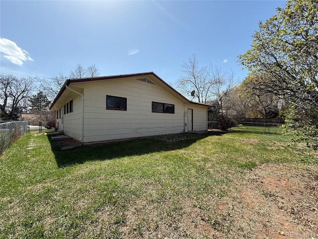 1906 Larkspur Dr, Fort Collins, CO 80521 - view of side of home with a yard and a fenced backyard