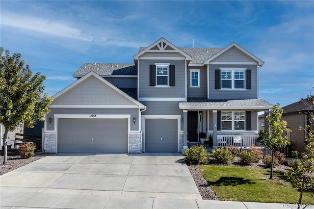 craftsman-style house featuring a garage, a front lawn, and a porch