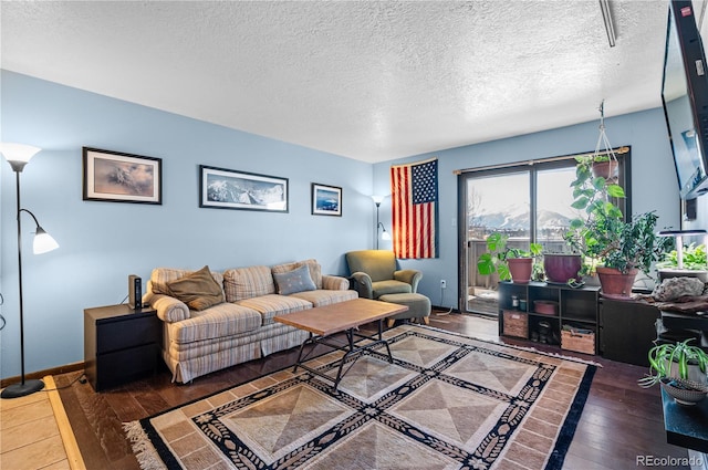 living area featuring a textured ceiling and dark wood-style flooring