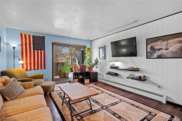 living area with dark wood-style floors, a baseboard radiator, baseboards, and a textured ceiling