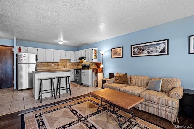 living room with light tile patterned floors and a textured ceiling