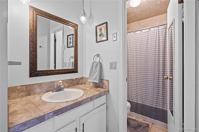 bathroom featuring toilet, tile patterned floors, a shower with curtain, and vanity