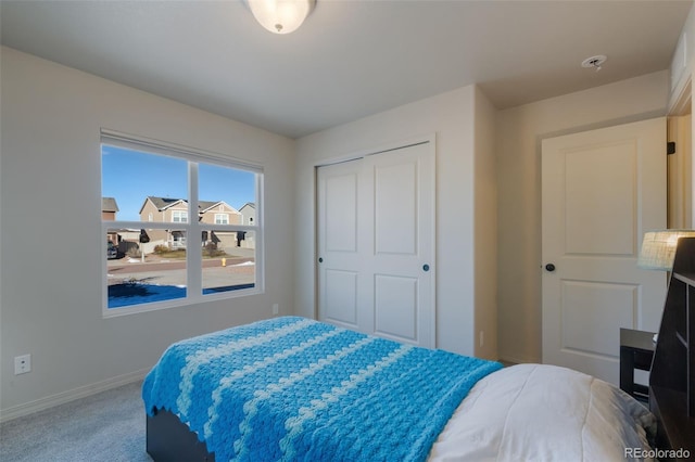 carpeted bedroom with a closet