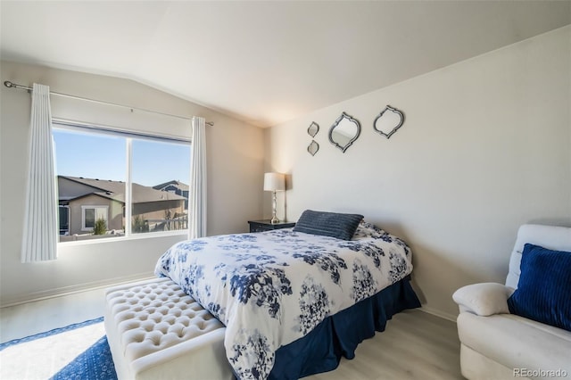 bedroom featuring vaulted ceiling and hardwood / wood-style floors