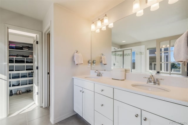 bathroom featuring vanity, tile patterned floors, and walk in shower