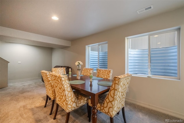 dining room with light colored carpet