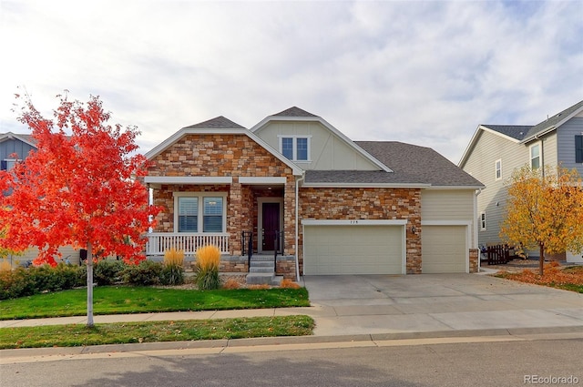 craftsman inspired home featuring a front yard and a garage