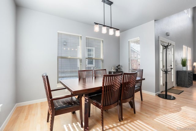 dining space with light hardwood / wood-style floors and a healthy amount of sunlight