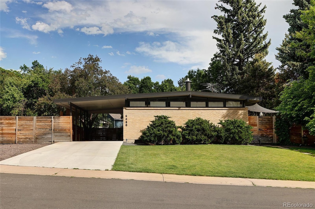 6080 S Detroit St, Centennial, CO 80121 - view of front facade with driveway, an attached carport, and brick siding