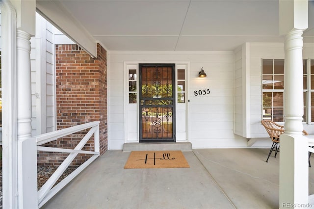 8035 S Garfield Way, Centennial, CO 80122 - view of exterior entry featuring covered porch and brick siding