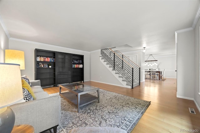 8035 S Garfield Way, Centennial, CO 80122 - living room with stairway, wood finished floors, crown molding, baseboards, and a chandelier
