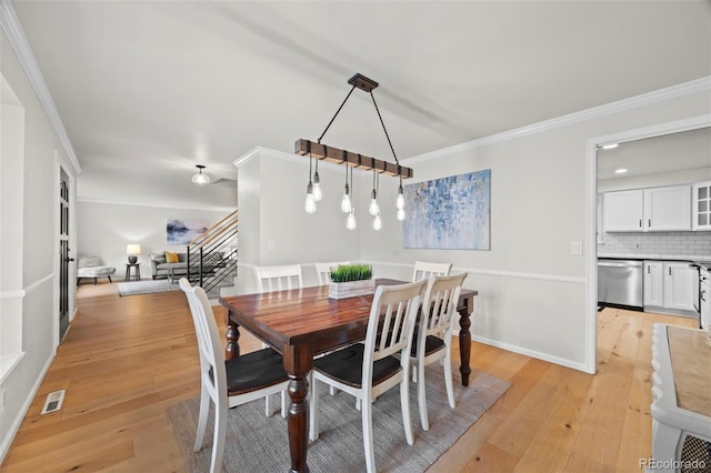 8035 S Garfield Way, Centennial, CO 80122 - dining space featuring light wood finished floors, crown molding, stairs, and baseboards
