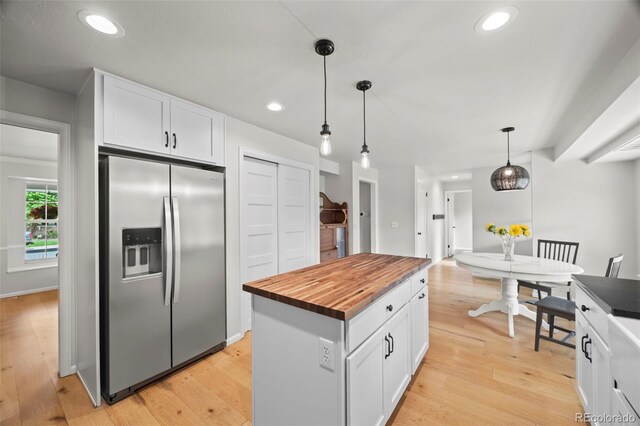 8035 S Garfield Way, Centennial, CO 80122 - kitchen featuring stainless steel fridge, wooden counters, white cabinetry, light wood finished floors, and pendant lighting