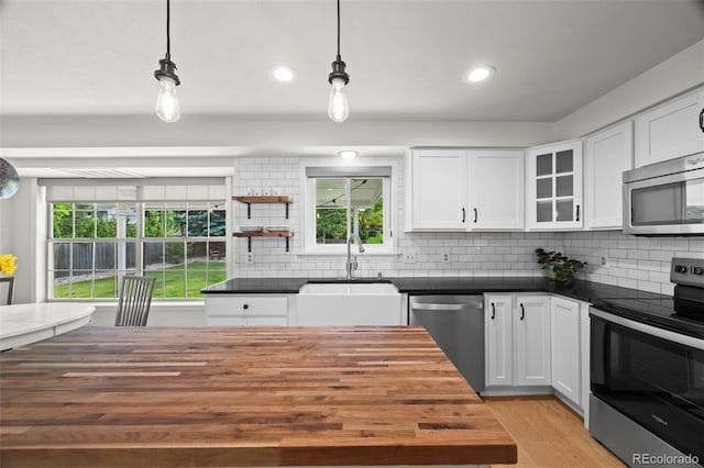 8035 S Garfield Way, Centennial, CO 80122 - kitchen featuring appliances with stainless steel finishes, butcher block counters, healthy amount of natural light, and recessed lighting