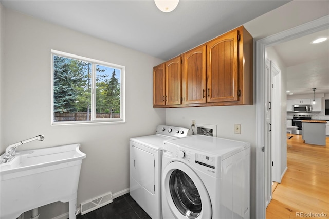 8035 S Garfield Way, Centennial, CO 80122 - laundry room featuring cabinet space, independent washer and dryer, baseboards, recessed lighting, and light wood finished floors