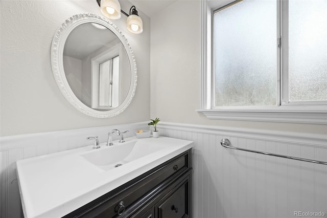 8035 S Garfield Way, Centennial, CO 80122 - bathroom featuring a wainscoted wall and vanity