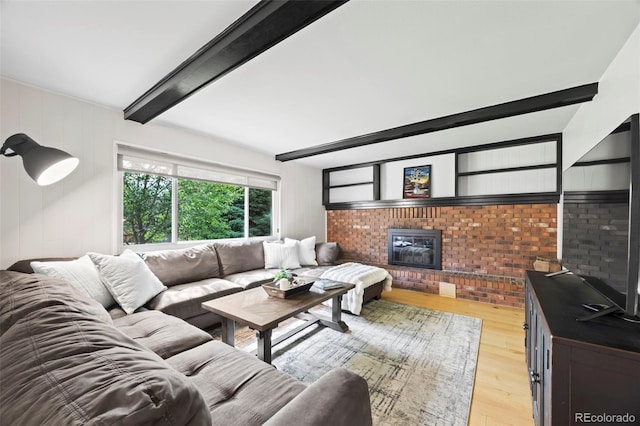 8035 S Garfield Way, Centennial, CO 80122 - living area featuring beamed ceiling, light wood-style flooring, a brick fireplace, and brick wall
