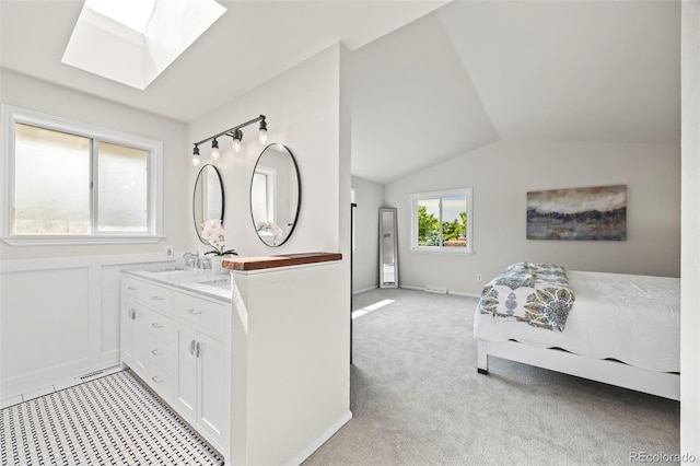 8035 S Garfield Way, Centennial, CO 80122 - bedroom featuring a skylight, a sink, lofted ceiling, and light carpet