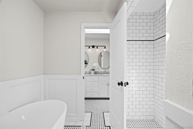 8035 S Garfield Way, Centennial, CO 80122 - bathroom featuring vanity, a freestanding bath, tiled shower, a textured wall, and wainscoting