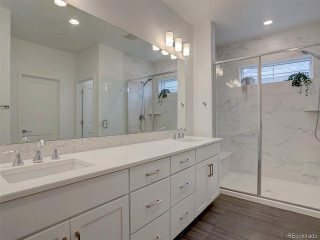 11246 Bellsong Ln, Littleton, CO 80125 - bathroom with double vanity, a marble finish shower, and recessed lighting