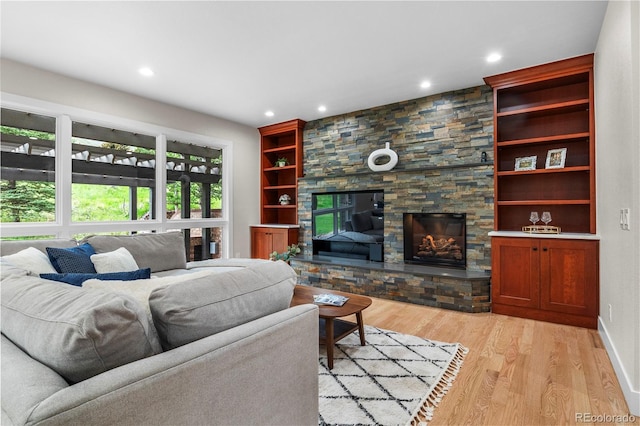 10 Summit Ash, Littleton, CO 80127 - living area featuring light wood finished floors, recessed lighting, and a fireplace