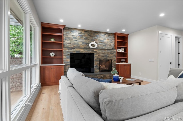 10 Summit Ash, Littleton, CO 80127 - living area with light wood finished floors, recessed lighting, baseboards, and a fireplace