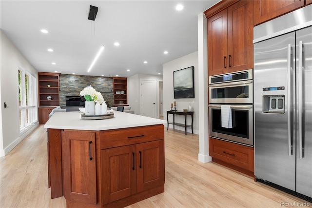 10 Summit Ash, Littleton, CO 80127 - kitchen with stainless steel appliances, light wood finished floors, recessed lighting, and built in features
