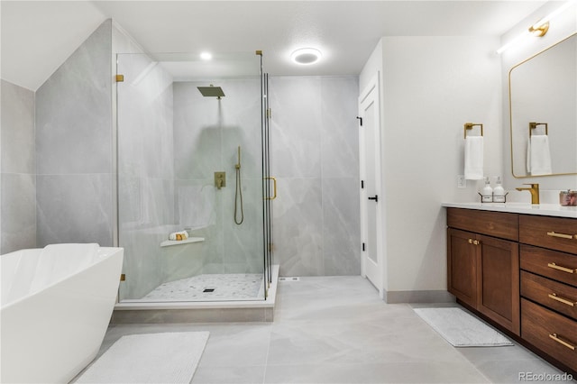 10 Summit Ash, Littleton, CO 80127 - full bath with vanity, a stall shower, a soaking tub, and tile patterned flooring