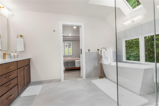 10 Summit Ash, Littleton, CO 80127 - bathroom featuring a skylight, vanity, a soaking tub, and connected bathroom