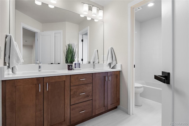 10 Summit Ash, Littleton, CO 80127 - full bathroom featuring toilet, double vanity, tile patterned flooring, and baseboards